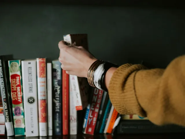 A reader choosing a book from a shelf