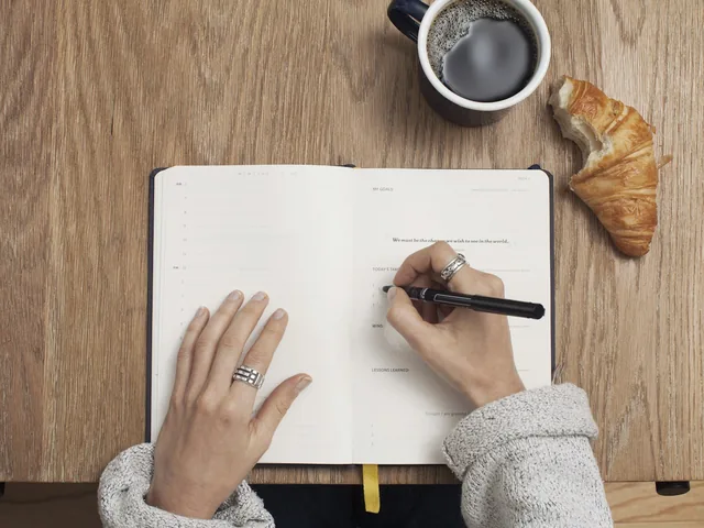A writer developing a draft in a notebook